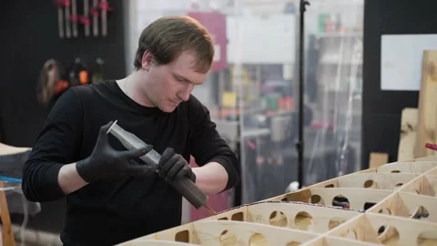 Master applies a glue on the frame surf Board Video stock 132261376