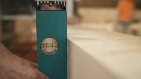 Master applies level check vertical of wooden bar Stock Footage 145808470