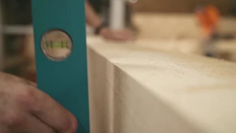 Master applies level check vertical of wooden bar Stock-Footage 145808508