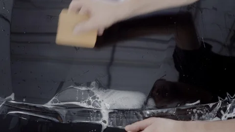 The master applies a protective layer on the surface of the car Stock Footage 93627867