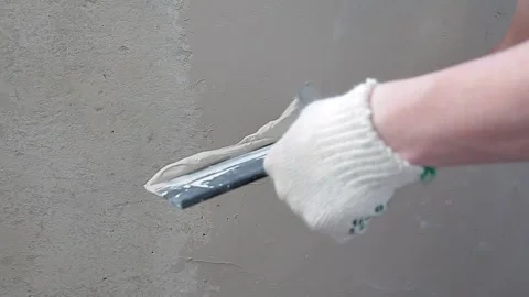 The master applies putty to the spatula. Renovation of the balcony, apartment Stock Footage 133333634