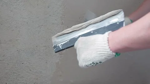 The master applies putty to the spatula. Renovation of the balcony, apartment Stock Footage 140750669