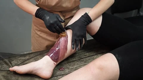 Master applies a Sugar Paste for Depilation on the feet of the client Stock Footage 266153848