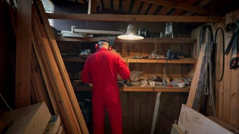 The master approaches the shelves in his workshop. Stock Footage 318586697