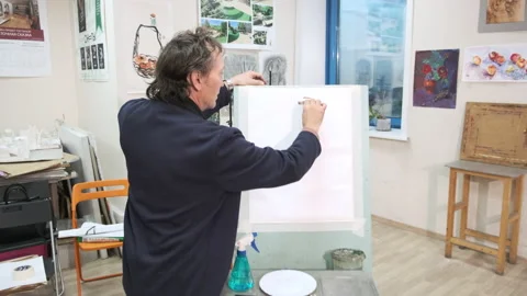 A master of the art school explains to students painting Stock Footage 144927473