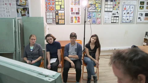 A master of the art school explains to students painting Stock Footage 144929969