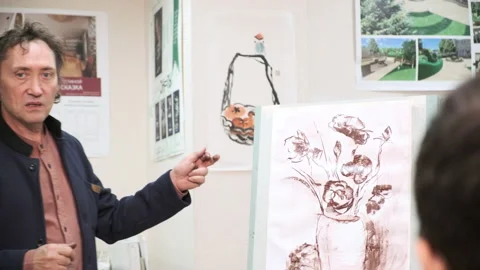 A master of the art school explains to students painting Stock Footage 144932007