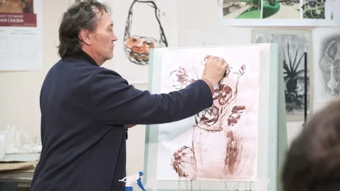 A master of the art school explains to students painting Stock Footage 144932831