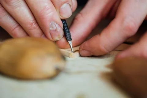 Master artisan luthier working on the creation of a violin. painstaking detailed Stock Photos