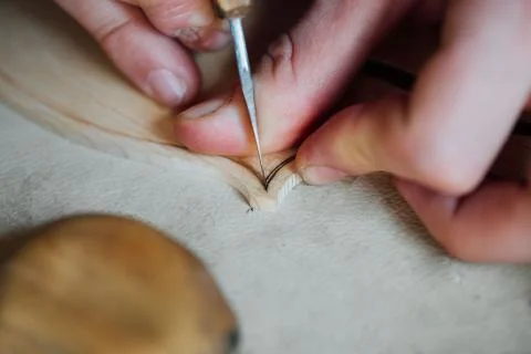 Master artisan luthier working on the creation of a violin. painstaking detailed Stock Photos