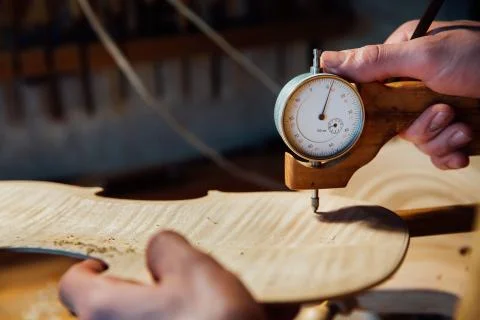 Master artisan luthier working on the creation of a violin. painstaking detailed Stock Photos
