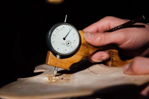 Master artisan luthier working on the creation of a violin. painstaking detailed Stock Photos