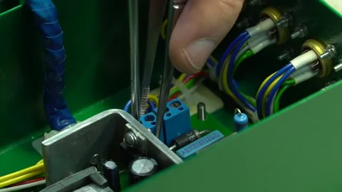 The master assembles the junction box Stock Footage 157758600