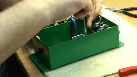 The master assembles the junction box Stock Footage 157758668