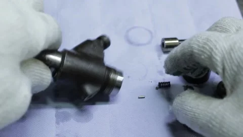 The master assembles the parts into a mechanism Stock Footage 145660847
