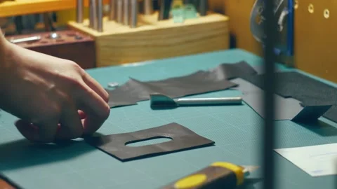 The master is assembling a wallet made of genuine leather and velor Stock Footage 169594751