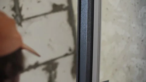 Master attaches the insulation to the window frame Stock Footage 284155208