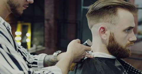 A master barber Use the milling machine to shorten the hair on the neck. Stock Footage 140248678