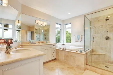 Master bathroom interior with beige tile floor , double sink , bath tub and g Stock Photos