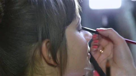 Master in the beauty salon to apply makeup for eyes model Stock Footage 40063315
