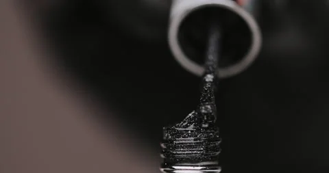 Master in black gloves holds black and silver nail polish with an open bottle Video stock 149364580