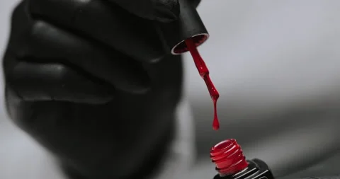 Master in black gloves holds red nail polish with an open bottle Video stock 149367472
