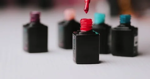Master in black gloves holds red nail polish with an open bottle Video stock 149367943