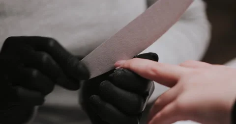 Master in black gloves making manicure using electric equipment for nails. Stock Footage 149366213
