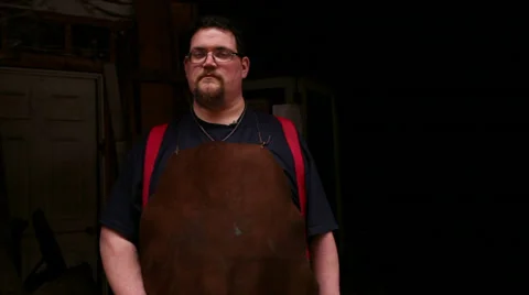 Master blacksmith stands in entryway of his historic shop, slider, medium shot Stock Footage 39015746