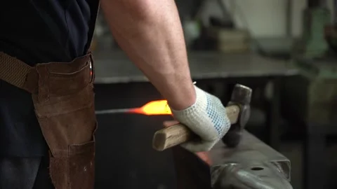 Master Blacksmith at Work: The Art of Forging Metal into Shape with Precision Stock Footage 341316608