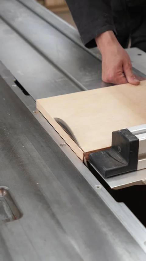 Master builder cuts a wooden panel on a format cutting machine Video stock 317414686