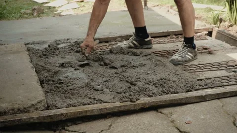 The master builder levels the fresh concrete terrace with a metal trowel Video stock 205834892