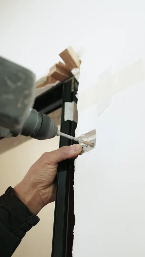 Master builder makes installation of doors and repairs inside house Stock Footage 302984939