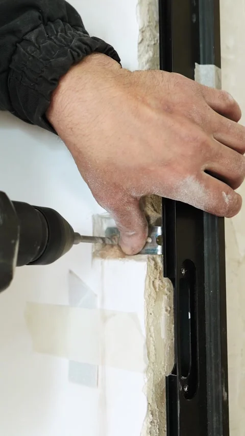 Master builder makes installation of doors and repairs inside house Stock Footage 302987090