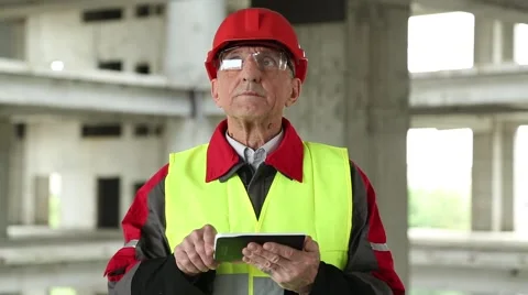 Master builder with tablet PC at construction site Stock Footage 55081220
