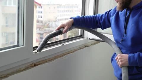 Master builder vacuums window  with vacuum cleaner before renovation Video stock 317395067