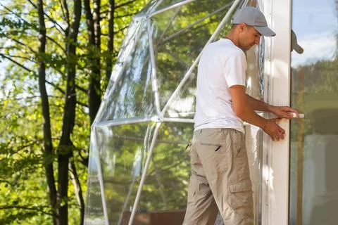 The master builds the dome. Outside spherical glamping dome. Hemispherical Stock Photos