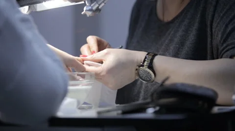 Master in the cabin makes manicure young girl Stock Footage 61440477