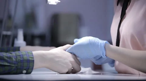 Master in the cabin makes manicure young girl close-up of hands Stock Footage 61440484