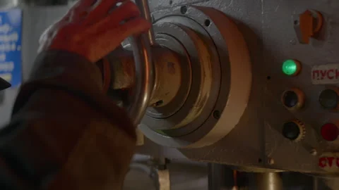 Master carefully presses button on control panel of lathe in workshop Stock Footage 303110574