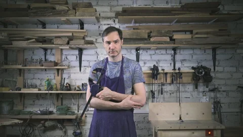 Master carpenter in an apron in his workshop. Small business Stock Footage 102567587