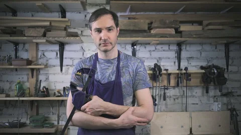 Master carpenter in an apron in his workshop. Small business Stock Footage 102567833