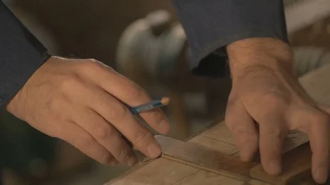 Master carpenter makes basting on the Board with a pencil, draws, craftsman work Stock Footage 69728013