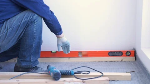 Master carpenter mounts pine wood floor - eco-friendly flooring. screwing lag to Видео 107165502