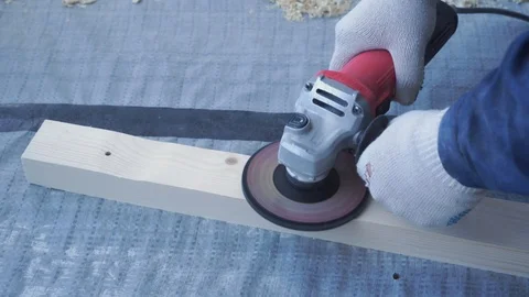 Master carpenter mounts pine wood floor - eco-friendly flooring. screwing lag to Stock Footage 107445611