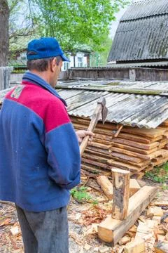 Master carpenter professionally working with an ax Stock Photos