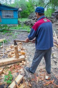 Master carpenter professionally working with an ax Stock Photos