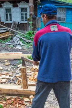 Master carpenter professionally working with an ax Stock Photos