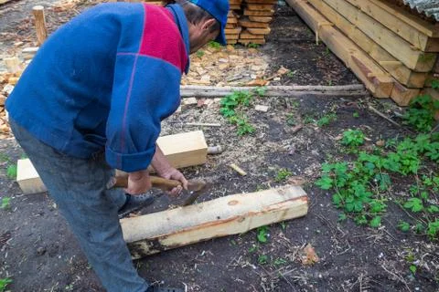 Master carpenter professionally working with an ax Stock Photos