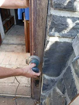 Master Carpenter Restoring Rustic Wooden Door On Historic Building Stock Photos